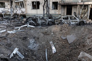 KYIV, UKRAINE - Mar. 20, 2022: Ukrayna 'da savaş. Patlayıcı huni, konut binası ve araçlar Rus roketinin Kyiv 'e yaptığı saldırıdan sonra enkaz düşmesi sonucu hasar gördü.