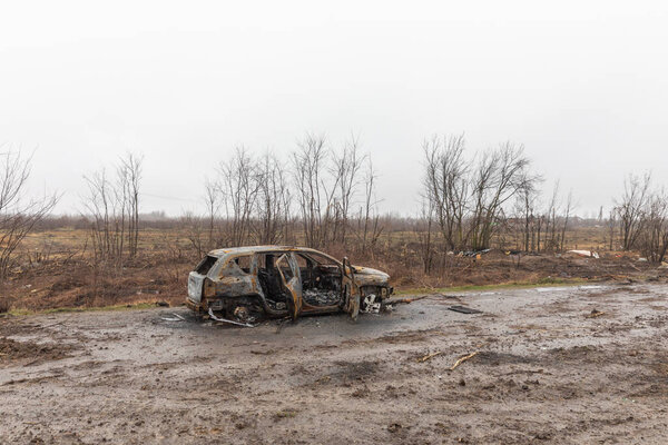 KYIV REG., UKRAINE - Apr. 02, 2022: A destroyed and burnt cars seen on a Kyiv-Zhytomyr highway 20 km from Kyiv.