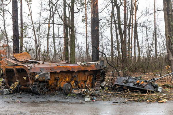 DMITRIVKA, UKRAINE - Apr. 02, 2022: Broken tanks and combat vehicles of the Russian invaders near the village of Dmitrievka, Kiev region.