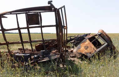 CHERNIHIV REG, UKRAINE - Jun. 19, 2022: Ukrayna 'da savaş. Buğday tarlasının ortasında parçalanmış bir kamyon. Rus faşistlerin işgalinden sonra Ukrayna manzaraları