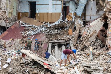 KHARKIV, UKRAINE - Aug. 01, 2022: Volunteers clearing the rubble of a destroyed house as a result of the Russian shelling of the city of Kharkiv