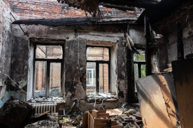 KHARKIV, UKRAINE - Aug. 01, 2022: Burnt and damaged city hospital in the historical building in Kharkiv. Destroyed building in historical downtown as a consequences of Russian shelling in Kharkiv
