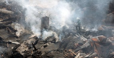 KHARKIV, UKRAINE - Jul. 30, 2022: Firefighter works in highly damaged specialized school following night Russian rocket attach on Kharkiv, Ukraine