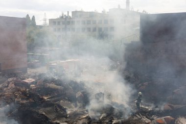 KHARKIV, UKRAINE - Jul. 30, 2022: Firefighter works in highly damaged specialized school following night Russian rocket attach on Kharkiv, Ukraine