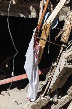 CHUHUIV, UKRAINE - Jul. 29, 2022: Traditional Ukrainian shirt is seen in the middle of destroyed by rocket the cultural center in Chuhuiv, Kharkiv region, Ukraine