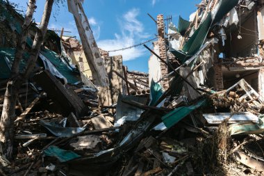 CHUHUIV, UKRAINE - Jul. 29, 2022: Brick ruined wall of destroyed by rocket the cultural center in Chuhuiv, Kharkiv region, Ukraine