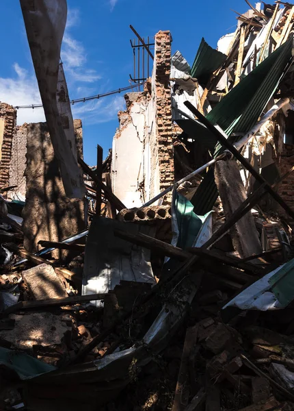 CHUHUIV, UKRAINE - Jul. 29, 2022: Brick ruined wall of destroyed by rocket the cultural center in Chuhuiv, Kharkiv region, Ukraine
