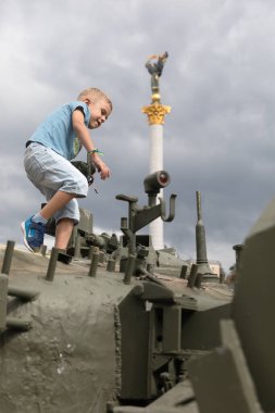 KYIV, UKRAINE - Aug. 20, 2022: Children on tanks. An exhibition of destroyed Russian equipment is being organized on Khreshchatyk in Kyiv