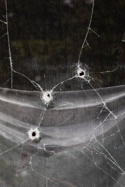 KHARKIV, UKRAINE - Jul. 30, 2022: Window with holes from shell fragments. Kharkov during the war with the Russian Federation.