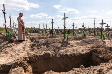 BUCHA, UKRAINE - Sep. 02, 2022: Burial of the remains of 13 unidentified and two identified people who were killed in the Bucha district during the Russian occupation
