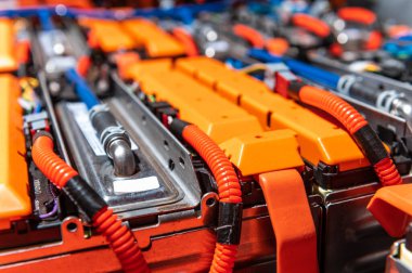 Electric car battery with power connections closeup. Blue toned. EV car battery at maintenance