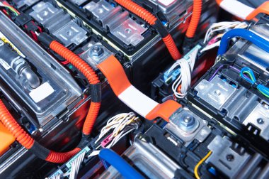 Electric car battery with power connections closeup. Blue toned. EV car battery at maintenance