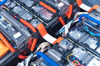 Electric car battery with power connections closeup. Blue toned. EV car battery at maintenance