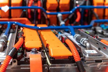 Electric car battery with power connections closeup. Blue toned. EV car battery at maintenance