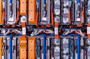 Electric car battery with power connections closeup. Blue toned. EV car battery at maintenance
