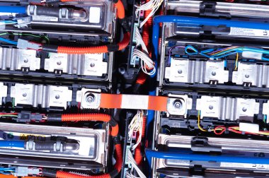 Electric car battery with power connections closeup. Blue toned. EV car battery at maintenance