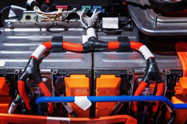Electric car battery with power connections closeup. Blue toned. EV car battery at maintenance