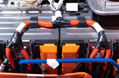 Electric car battery with power connections closeup. Blue toned. EV car battery at maintenance