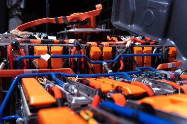 Electric car battery with power connections closeup. Blue toned. EV car battery at maintenance