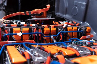 Electric car battery with power connections closeup. Blue toned. EV car battery at maintenance