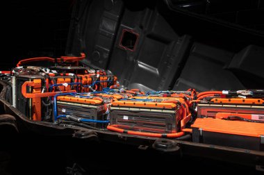 Electric car battery with power connections closeup. Blue toned. EV car battery at maintenance