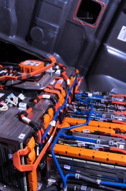 Electric car battery with power connections closeup. Blue toned. EV car battery at maintenance