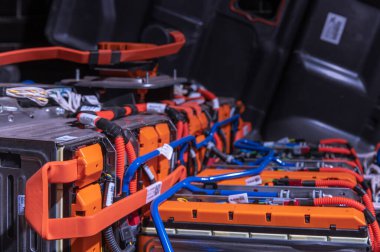 Electric car battery with power connections closeup. Blue toned. EV car battery at maintenance