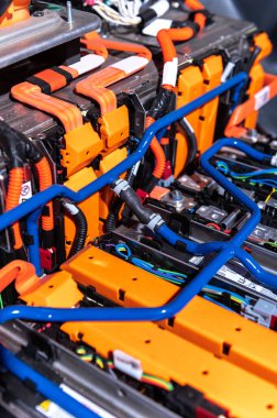 Electric car battery with power connections closeup. Blue toned. EV car battery at maintenance