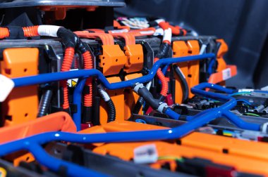 Electric car battery with power connections closeup. Blue toned. EV car battery at maintenance