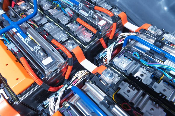 Electric car battery with power connections closeup. Blue toned. EV car battery at maintenance