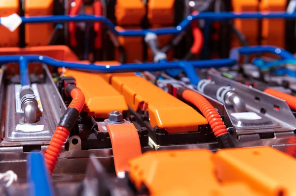 Electric car battery with power connections closeup. Blue toned. EV car battery at maintenance