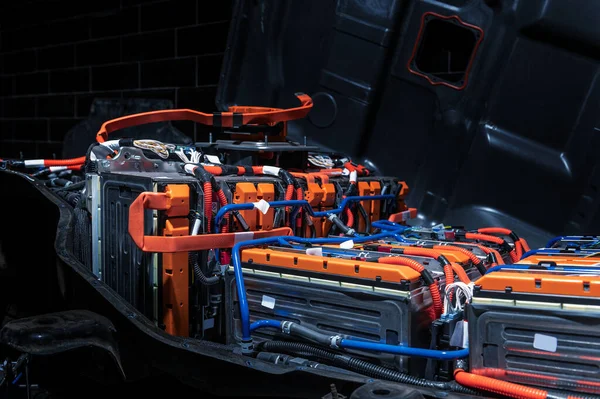 Electric car battery with power connections closeup. Blue toned. EV car battery at maintenance