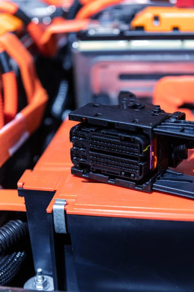 Electric car battery with power connections closeup. Blue toned. EV car battery at maintenance. High voltage power connector closeup