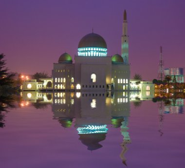 Mosque building with reflection on lake clipart
