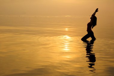 Asyalı kız sahilde Yoga gerçekleştirme