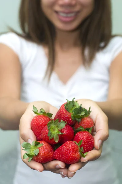 Asian girl holding strawberry — Stock Photo, Image