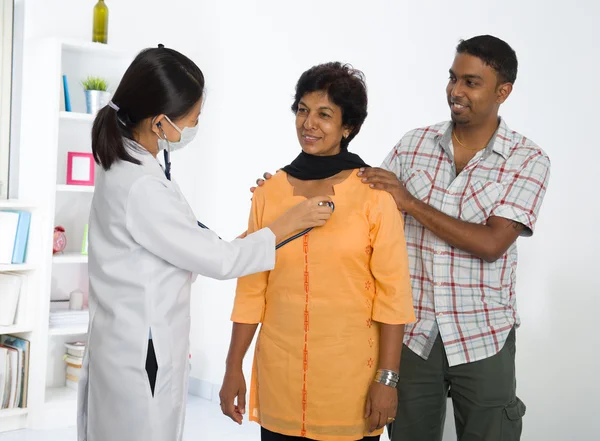 Indian senior medical checkup with an asian female doctor — Stock Photo, Image