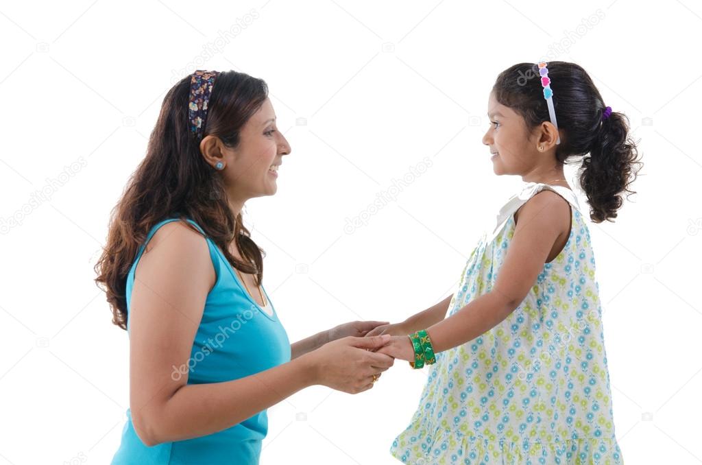 indian mother and daugther staring at each other