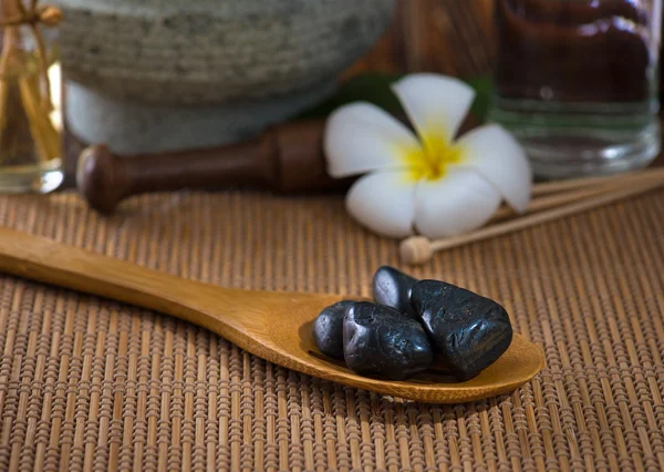 Hot stone massage with spa treatment items on the background — Stock Photo, Image
