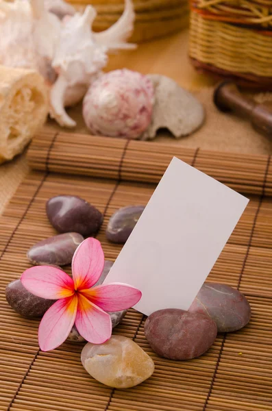 Tropical spa setup with frangipani flower hot rocks and massage — Stock Photo, Image