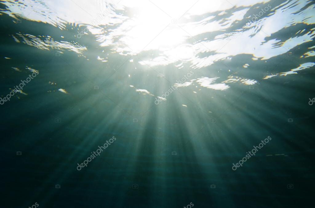 scuba diving shot of underwater sea with sun ray