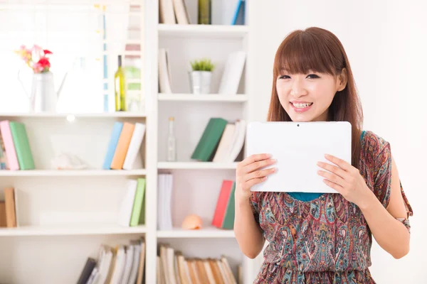 Chinese female tablet computer enjoying Internet surfing at her — Stock Photo, Image