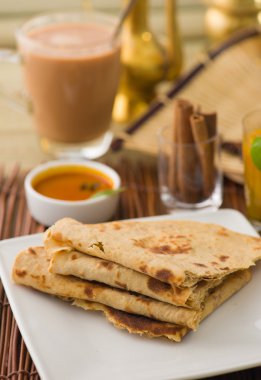 Chapati , Indian flat bread in plate usually served with curry clipart