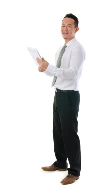 Full body Chinese Asian businessman using tablet-pc standing iso clipart