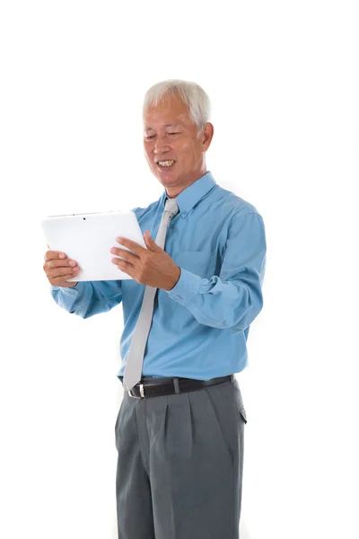 Senior chinese singaporean with a tablet business man isolated o — Stock Photo, Image