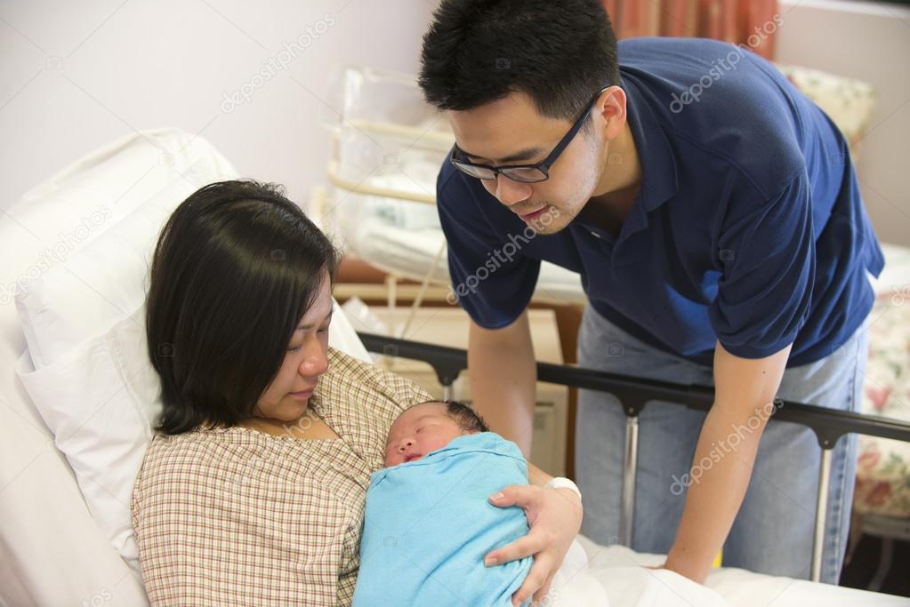 Asian chinese newborn baby girl and daddy in hospital