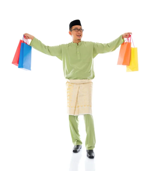 Traditional Malay male shopping and jumping in joy during hari r — Stock Photo, Image