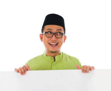Malay male with blank card during hari raya Eid al-Fitr celebrat clipart