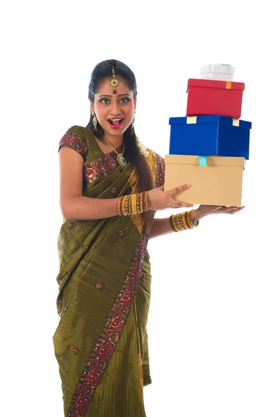 Portrait of a woman in traditional saree holding gifts and smili — Stock Photo, Image