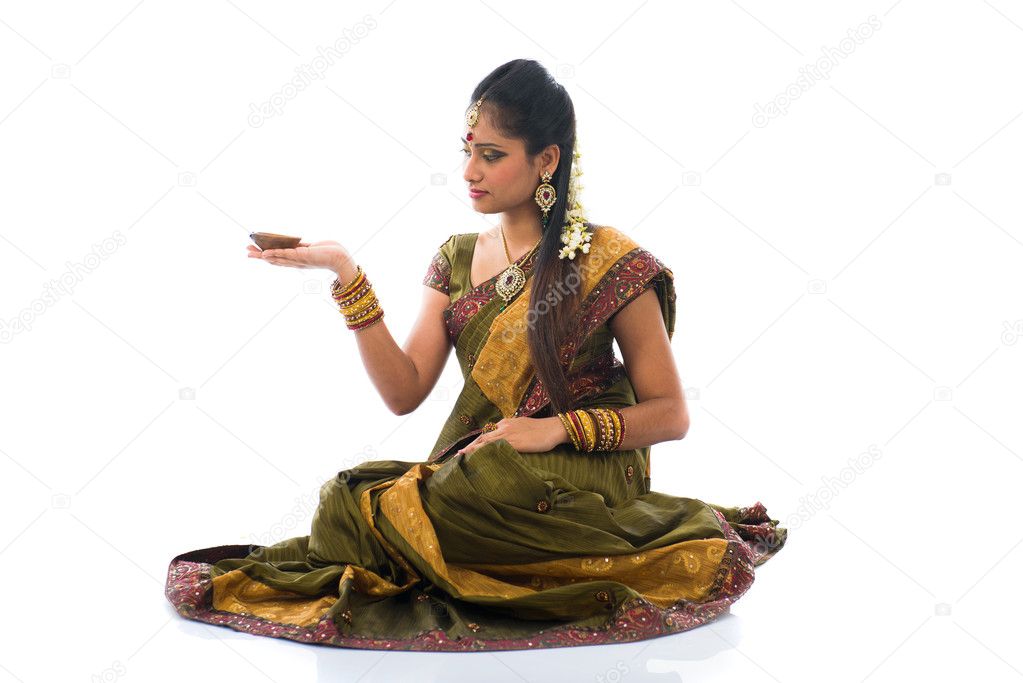 traditional indian woman with oil lamp during the celebration of